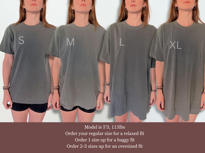 May include: Four charcoal grey short-sleeve t-shirts in sizes S, M, L, and XL. The shirts feature a crew neckline and a relaxed fit. Text on the image includes size labels S, M, L, XL and sizing advice: Model is 5'3, 115lbs. Order your regular size for a relaxed fit. Order 1 size up for a baggy fit. Order 2-3 sizes up for an oversized fit.