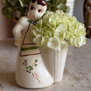 May include: A rustic wooden sign with the text "Welcome to our home" in white lettering. The sign features a distressed finish and a simple, inviting design, perfect for a front porch or entryway.