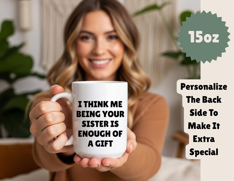 May include: White 425ml ceramic mug with the text "I THINK ME BEING YOUR SISTER IS ENOUGH OF A GIFT". The mug has a handle and is held by a person. The mug is a gift for a sister.