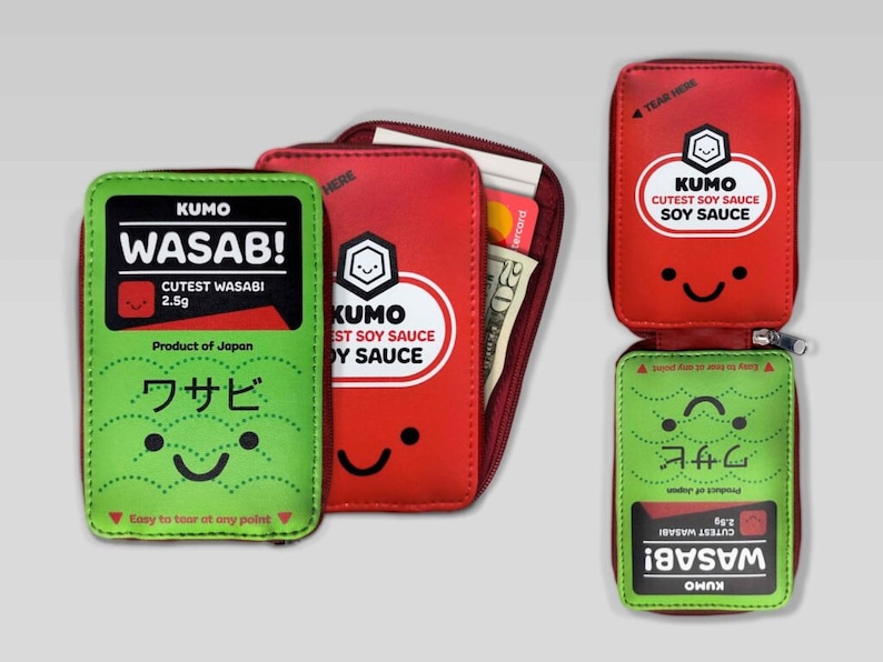 May include: A red and green zippered wallet with a cartoon design. The front of the wallet features a red soy sauce packet with the text "KUMO CUTEST SOY SAUCE SOY SAUCE". The back of the wallet features a green wasabi packet with the text "KUMO WASAB! CUTEST WASABI 2.5g Product of Japan ワサビ Easy to tear at any point".