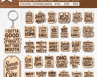 May include: A bundle of 32 laser-cut wooden keychains with funny sayings. The keychains feature various shapes and phrases like "I Gotta Good Heart But This Mouth" and "Swear Because Care".