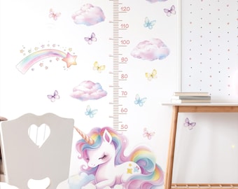 May include: A whimsical wall decal set featuring a unicorn, clouds, butterflies, and a rainbow. A height chart in inches is included. The design is in soft pastel colors, perfect for a child's bedroom or nursery.