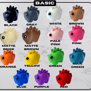 May include: A collection of twelve small, dinosaur-shaped figurines in various colors, including black, gray, white, brown, pale pink, pink, orange, yellow, green, blue, purple, and red. Each figurine has a textured back and a single, round eye. The word "BASIC" is at the top.