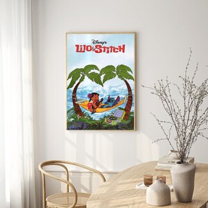 May include: A framed poster featuring the Disney movie Lilo & Stitch. The poster shows Lilo and Stitch relaxing in a hammock under palm trees. The text "Disney's Lilo & Stitch" is printed in red and white on a blue background.