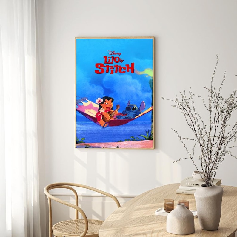 May include: A poster featuring the Disney movie Lilo & Stitch. The poster shows Lilo and Stitch in a hammock, with Lilo playing a ukulele. The background is a blue sky with clouds.