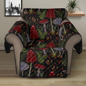 May include: A black quilted armchair cover with a red and green mushroom and fern pattern. The cover has a quilted design and is made of a soft, comfortable fabric.