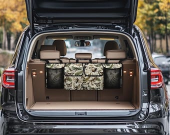 May include: Three black fabric storage organizers with mesh pockets hang from the headrests of the back seats of a black SUV. The organizers have a floral print with butterflies and leaves.