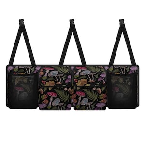 May include: Black car organizer with a colorful mushroom and fern pattern. Features two mesh pockets and two additional pockets. Adjustable black straps with plastic clips for easy attachment. A practical accessory for car organization.