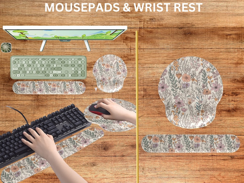 May include: A set of floral patterned mousepads and wrist rests. The mousepads are round and the wrist rests are rectangular. The wrist rests have a floral pattern with pink, white, and green flowers. The mousepads have a similar floral pattern with pink, white, and green flowers.