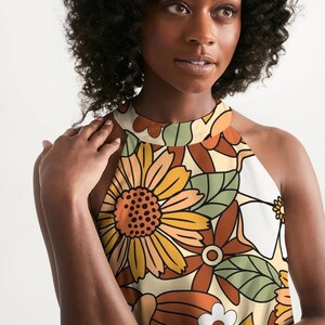 May include: A halter top with a retro floral print in shades of orange, brown, green, and white. The print features large flowers and leaves.
