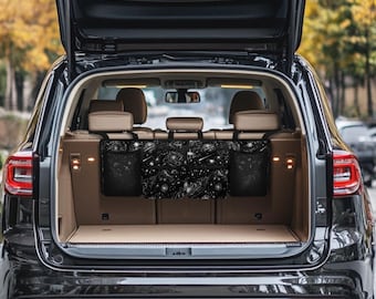 May include: Black car backseat organizer with a galaxy print and three mesh pockets. The organizer hangs from the headrests.