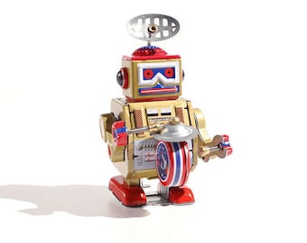 Samlarleksak i guldfärgad Big Band-robot i plåt