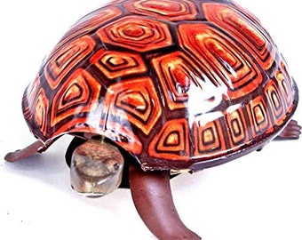 May include: A decorative turtle figurine with a glossy, patterned shell in shades of orange, red, and brown. The turtle's head and legs are a dark brown color. The figurine is a unique home decor item.