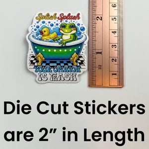 May include: Die-cut sticker featuring a green frog and a yellow rubber ducky in a bathtub with the text "Splish Splash Your Opinion Is Trash" printed on a white background. The sticker is 5 cm long.