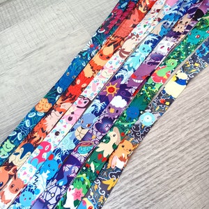 May include: A set of 10 colorful lanyards featuring different Pokemon characters. Each lanyard has a unique design with a variety of colors and patterns.