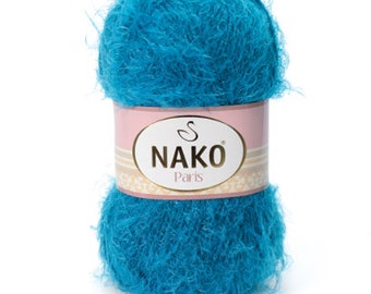 May include: A teal blue ball of yarn with a label that reads "NAKO Paris".