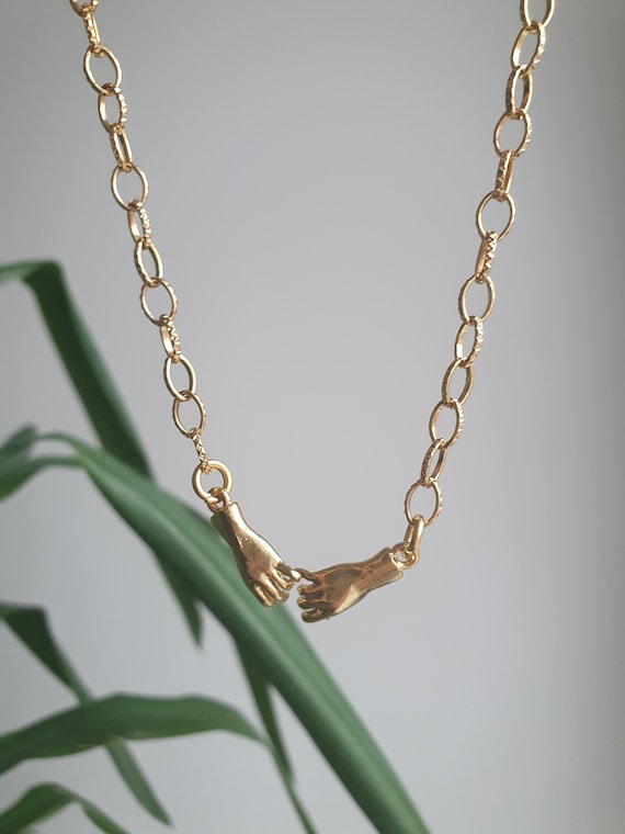 Holding hands necklace discount