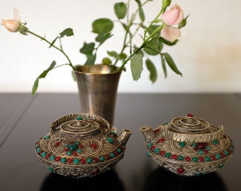 Teapot Pair, the symbol of Tibetan Hospitality gives a unique home decor accent. Filigree decorated and silver plated asian tea can set..