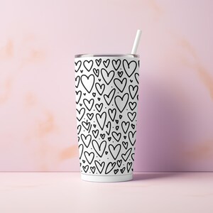 May include: White stainless steel tumbler with a black and white heart pattern. The tumbler has a straw.