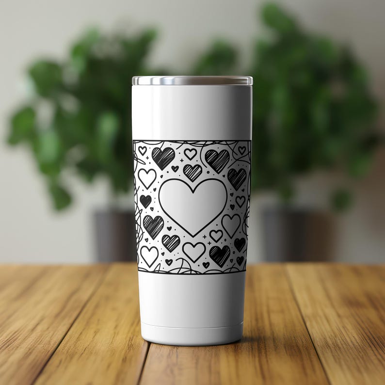 May include: White stainless steel tumbler with a black and white graphic of hearts and swirls.