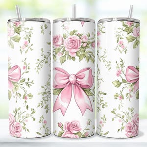 May include: Three stainless steel tumblers with a white background and a pink floral pattern. The pattern features pink roses, green leaves, and pink bows.
