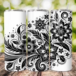 May include: Three stainless steel tumblers with black and white floral designs. The designs feature intricate swirls and flowers.
