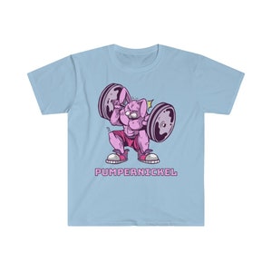 May include: Light blue t-shirt featuring a cartoon rabbit lifting weights. The rabbit is pink and muscular, wearing pink shorts and sneakers. The barbell has gray weights. The text "PUMPERNICKEL" is below the rabbit in pink letters.