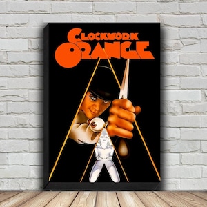 May include: A black and orange movie poster for the film "A Clockwork Orange". The poster features a man in a white costume holding a knife, with a woman in the background.