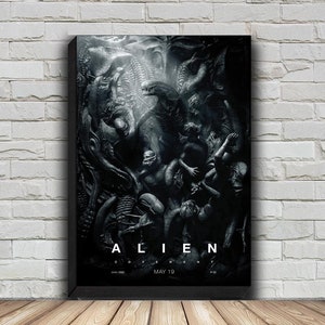 May include: A black and white movie poster for the film "Alien: Covenant". The poster features a close-up of a group of aliens in a dark, shadowy setting. The title of the film is written in white letters at the bottom of the poster, along with the release date, "May 19".