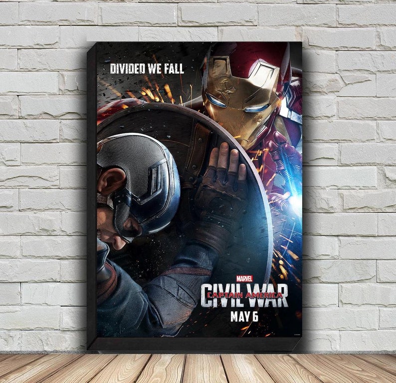 May include: A movie poster for Marvel's Captain America: Civil War. The poster features Captain America and Iron Man in a fight. The text on the poster reads "DIVIDED WE FALL" and "MARVEL CAPTAIN AMERICA CIVIL WAR MAY 6".