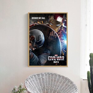 May include: A movie poster for Captain America: Civil War, featuring Captain America and Iron Man in a fight. The poster has the text "DIVIDED WE FALL" and "CIVIL WAR" with the release date "MAY 6".