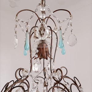 May include: A vintage chandelier with a bronze frame and crystal and blue glass drops.
