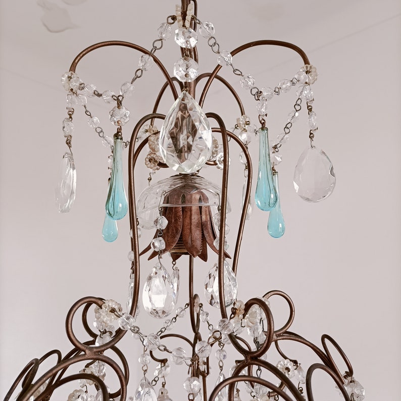 May include: A vintage chandelier with a bronze frame and crystal and blue glass drops.