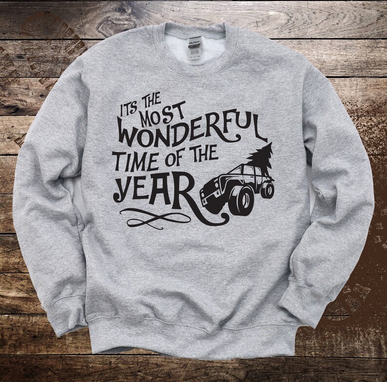 May include: Gray sweatshirt with a black graphic that says "It's the most wonderful time of the year" with a cartoon truck carrying a Christmas tree.