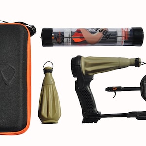 May include: A black and tan slingshot with a black handle, a black and orange trigger, and a tan pouch. The slingshot is accompanied by a black carrying case, a tan pouch, a tube of black arrows, and two black arrow tips.