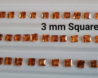 May include: A collection of 3 mm square orange gemstones arranged in three rows on a white surface. The text "3 mm Square" is printed below the top row of gemstones.