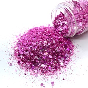 May include: A clear glass jar tipped over, spilling a large pile of vibrant pink glitter. The glitter is a mix of shapes and sizes, reflecting light. The background is white.