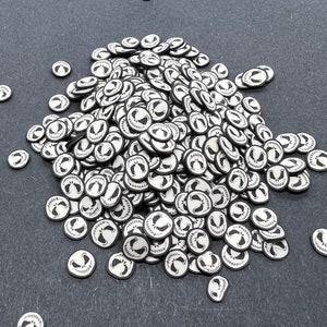 May include: A large pile of black and white round stickers with a Jack Skellington face design.
