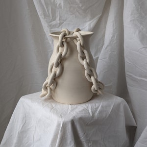 Handmade ceramic porcelain vase with a double chain in off white cream colour.