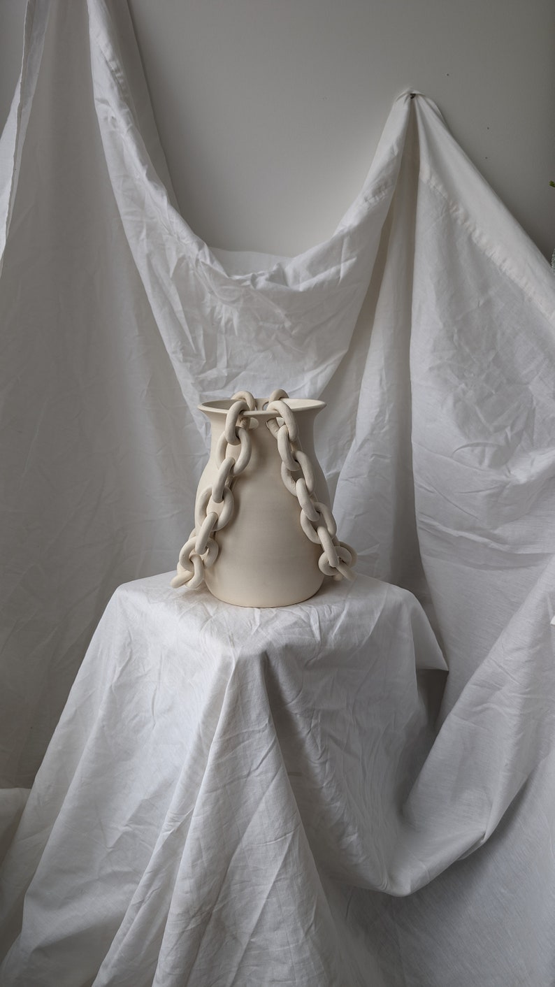 Handmade ceramic porcelain vase with a double chain in off white cream colour.