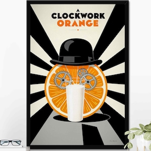 May include: A framed poster featuring the text A CLOCKWORK ORANGE in black and orange. The graphic shows a black bowler hat atop a sliced orange with two metallic gears as eyes and a tall glass of white milk centered in the foreground.