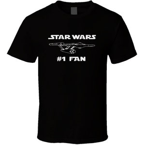 May include: Black t-shirt with white text that reads "STAR WARS #1 FAN" and a white outline of a spaceship.