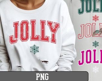 Puede incluir: Una sudadera blanca con un gráfico rojo desgastado "JOLLY" y un copo de nieve verde. La sudadera tiene un aspecto desgastado con agujeros en la tela.