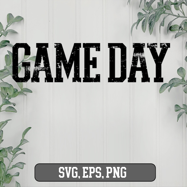 May include: Black and white distressed text graphic that reads "GAME DAY" on a white wood background. The graphic is surrounded by green leafy branches.