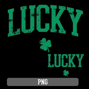 May include: Green and white distressed graphic design with the word "LUCKY" in a large font, repeated twice. A green shamrock is below each word.