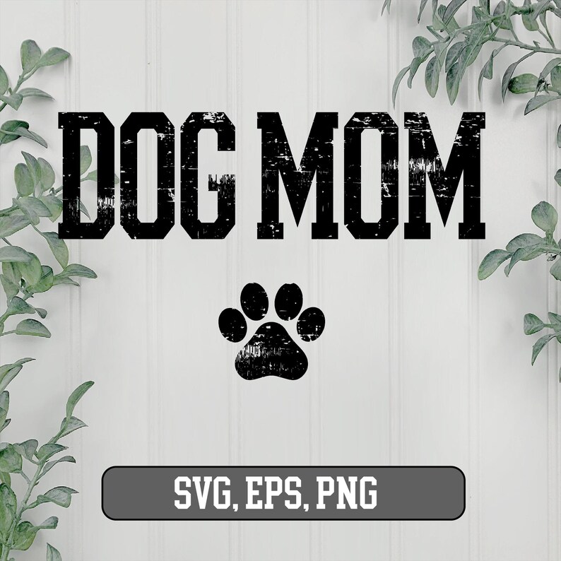 May include: Black and white graphic design with the text "DOG MOM" in a distressed font. A black paw print is below the text. The text "SVG, EPS, PNG" is at the bottom of the image.