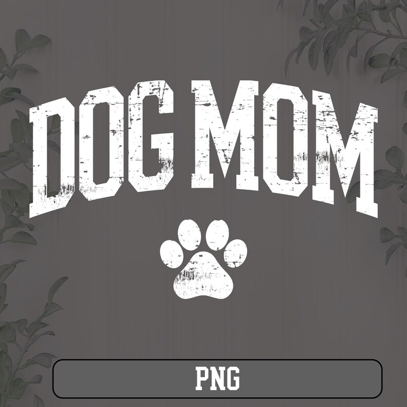 May include: White text on a gray background that reads "DOG MOM" with a white paw print below. The text has a distressed, vintage look.