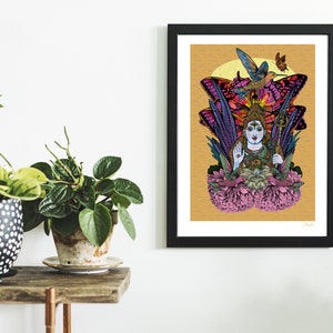 May include: A colorful illustration of a Hindu deity, Shiva, surrounded by butterflies and flowers. The artwork is framed in black and displayed on a white wall.