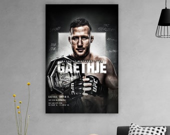 May include: A framed poster featuring Justin Gaethje, a UFC fighter, holding a championship belt. The poster has a dark background with the fighter's name prominently displayed. The poster includes details like weight class and fight dates.