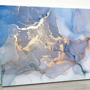 May include: Abstract painting with blue and gold swirls. The painting has a marbled effect with shades of blue and white, and gold accents.